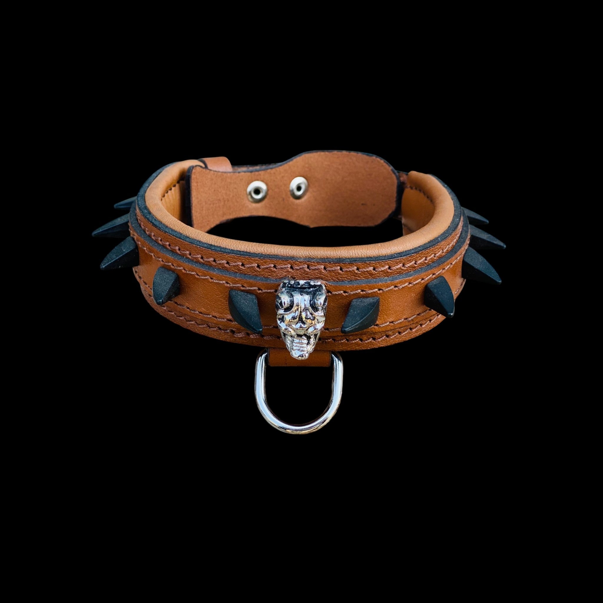 Side angle of brown leather Bully head dog collar decorated with black spikes and reinforced stitching.