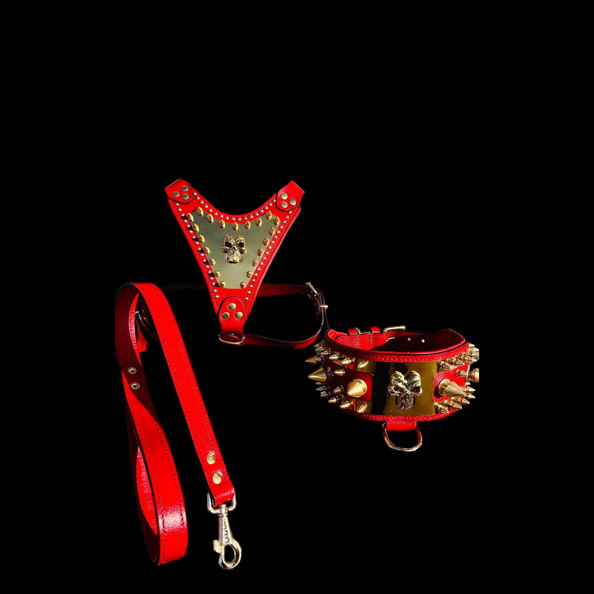 A&C Dog Collars red buffalo leather harness, spiked collar, and leash set with gold Punisher logo and brass hardware.