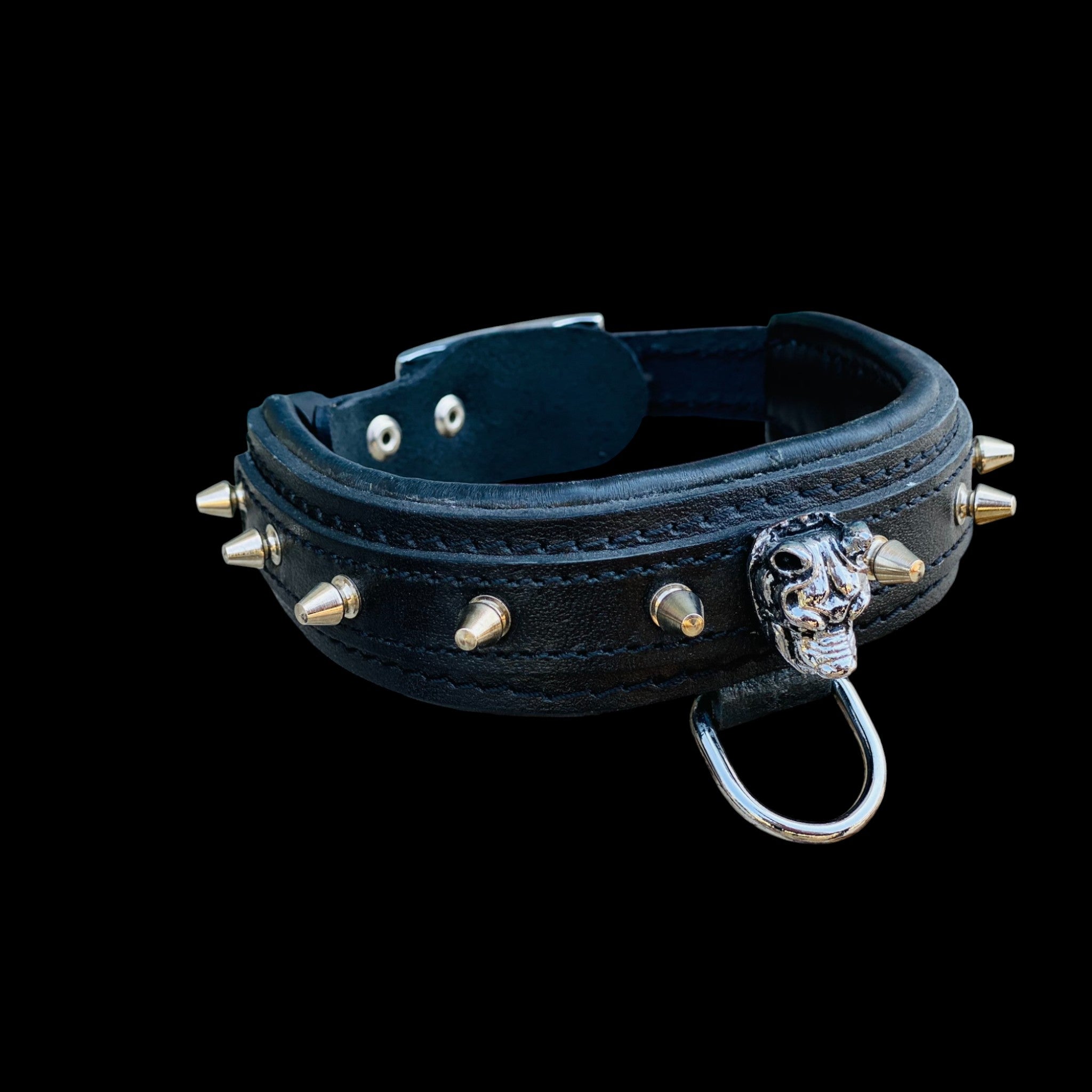 Angled photo of 1.57 inch wide black spiked leather collar with Bully logo centerpiece.