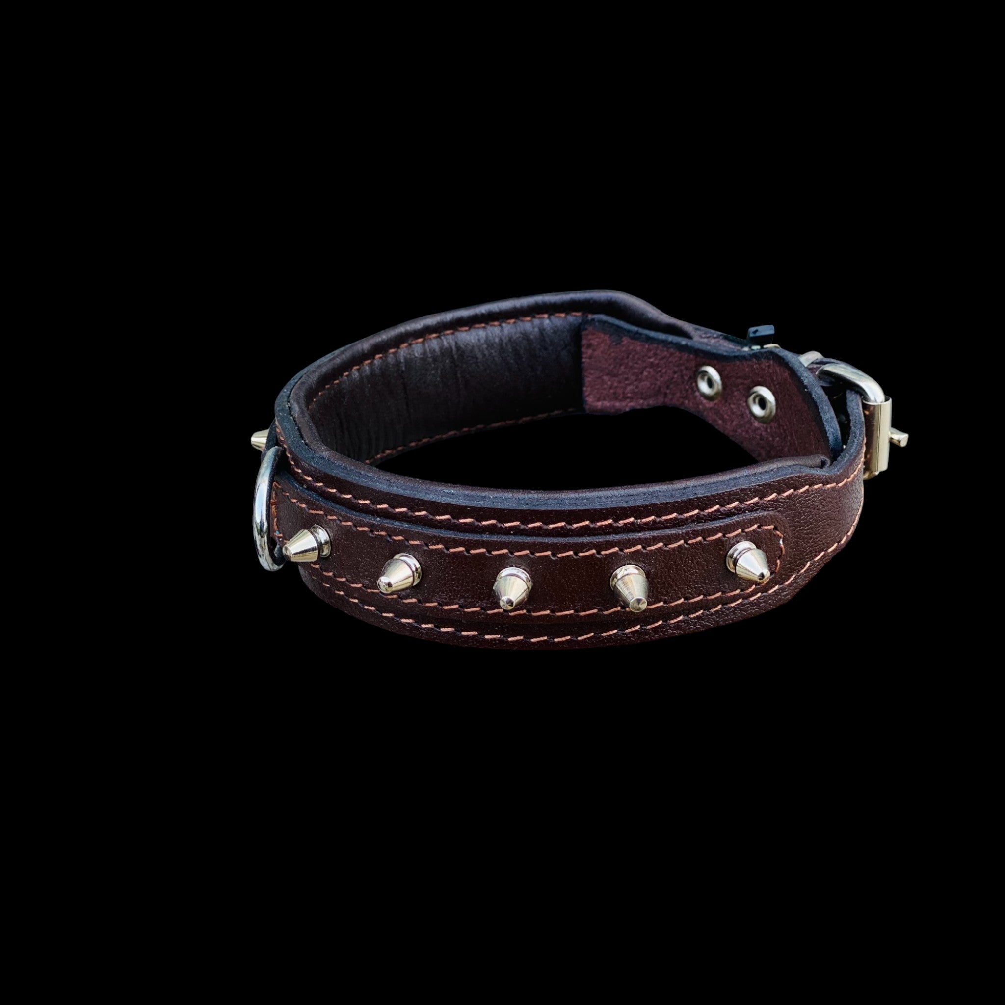Close-up detail of brown leather spiked dog collar showing strong stitching, steel spikes and premium handmade craftsmanship