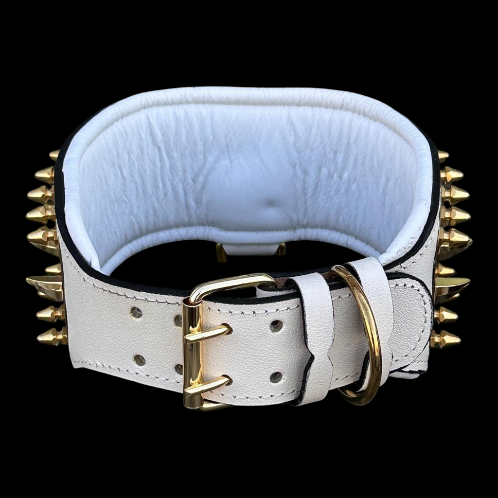Handmade white buffalo leather dog collar with gold punisher emblem and metal spikes, designed for luxury and durability.