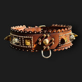 Handmade tan leather wide dog collar with lion emblem from A&C Dog Collars, showcasing sturdy leather and detailed lion design.